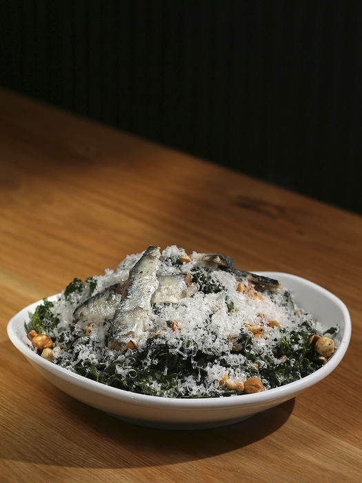 FIllustration - 1st place   - The kale caesar salad with lacinato kale, toasted hazelnuts, parmigiana reggiano, house caesar dressing and sardines, pictured at Harvest Pizzeria on Elm Street in Over-the-Rhine.  (Kareem Elgazzar / Cincinnati Enquirer)